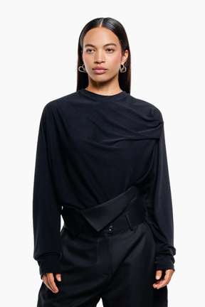 Person wearing a black outfit black top and pants 
