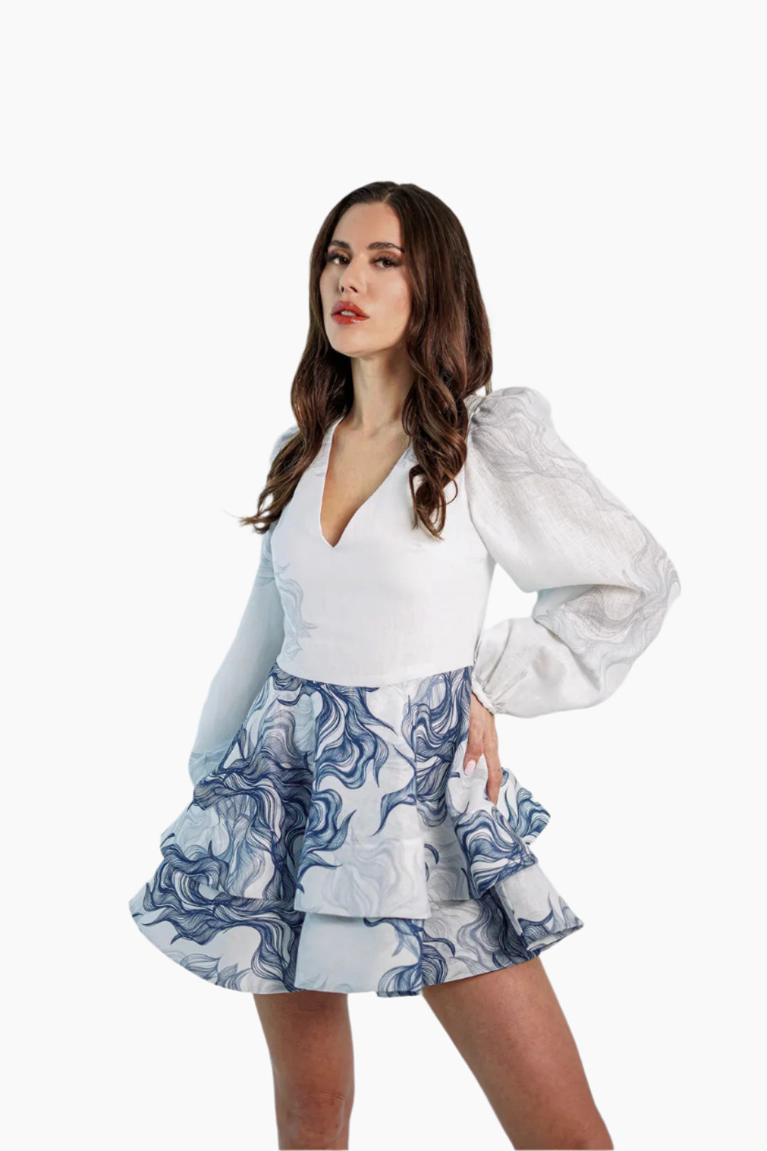 women wearing a short linen dress, long and puffed sleeves, featuring a  ruffle skirt.