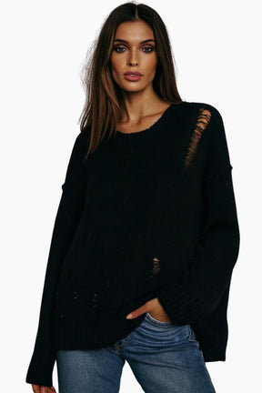 Woman wearing a black sweater with lace details 