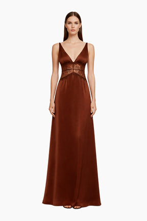 Woman wearing a brown evening gown with a lace bodice 