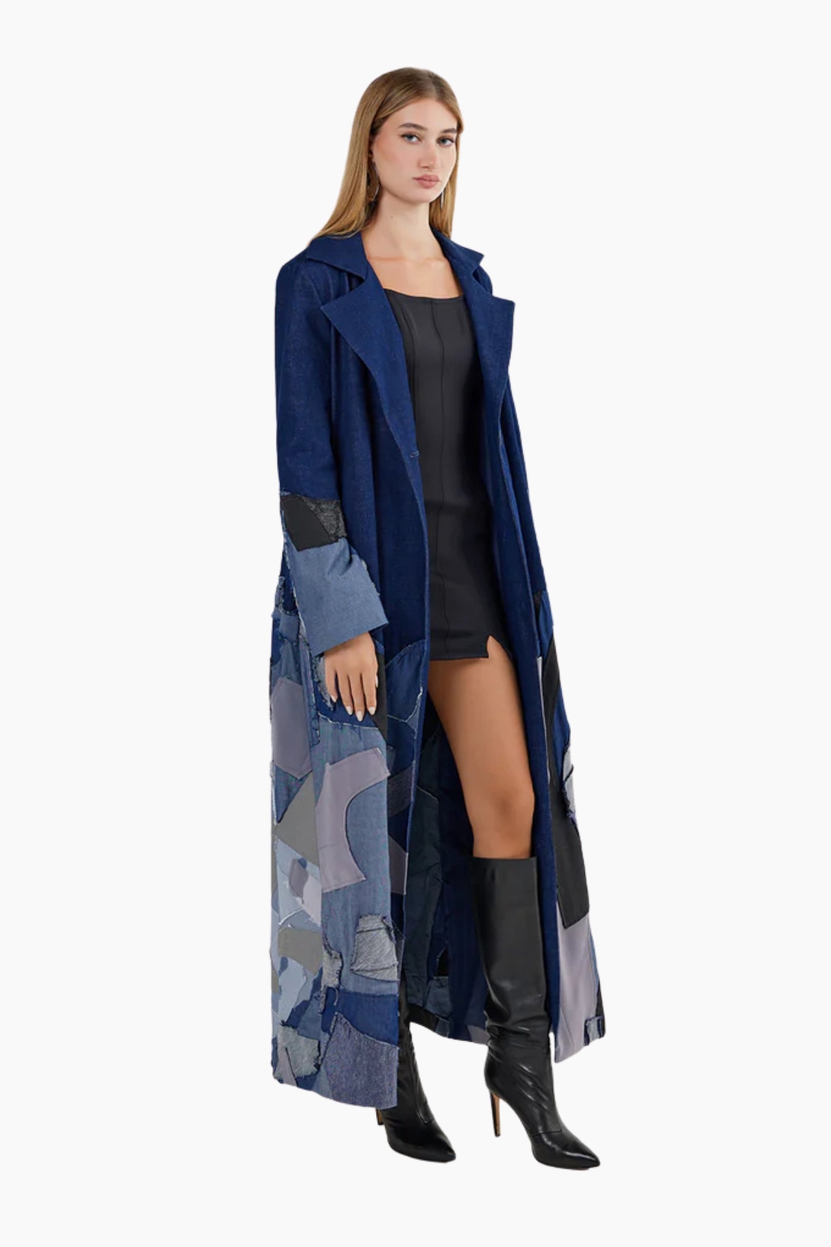 Woman wearing a long blue coat with a patterned design 