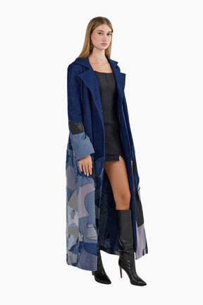 Woman wearing a long blue coat with a patterned design 