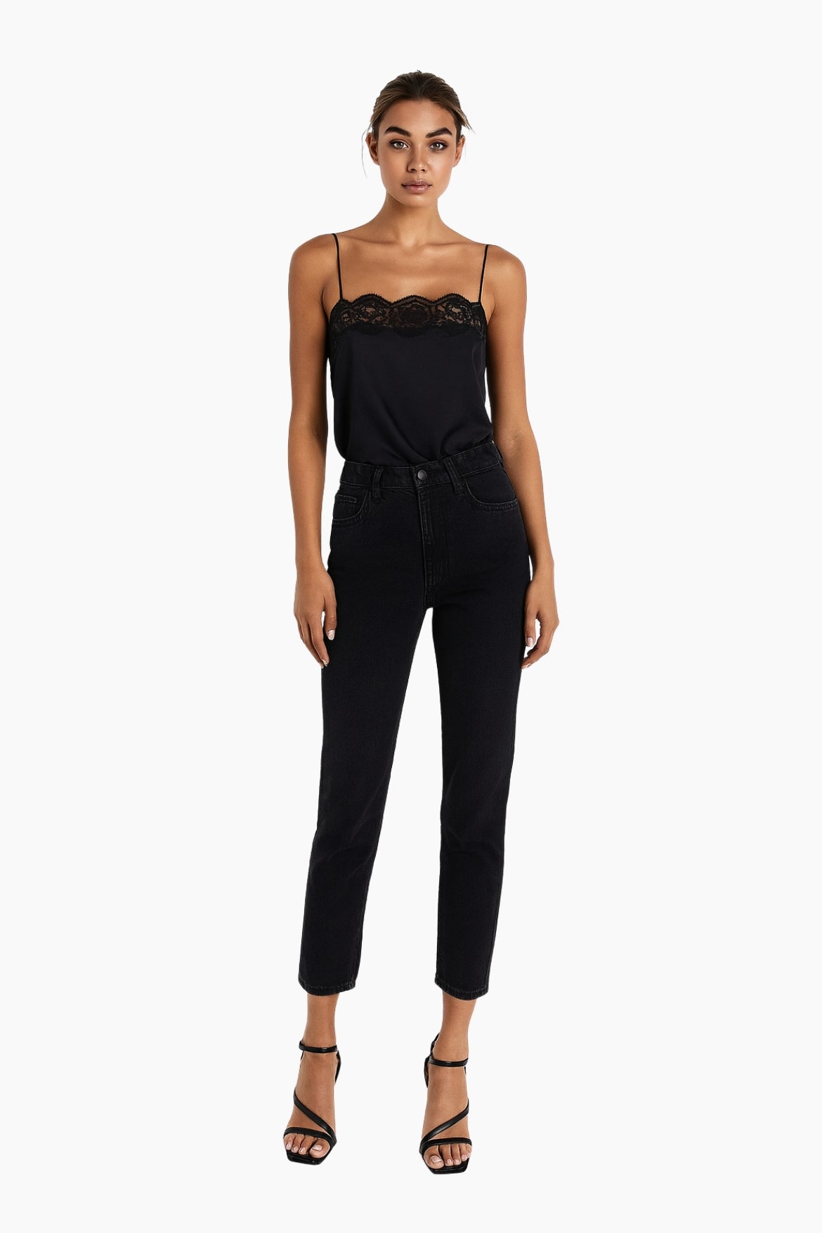 Woman wearing a black jumpsuit with lace detailing 