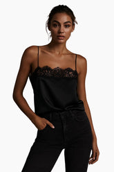 Woman wearing a black lace top and black pants 