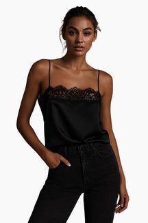 Woman wearing a black lace top and black pants 
