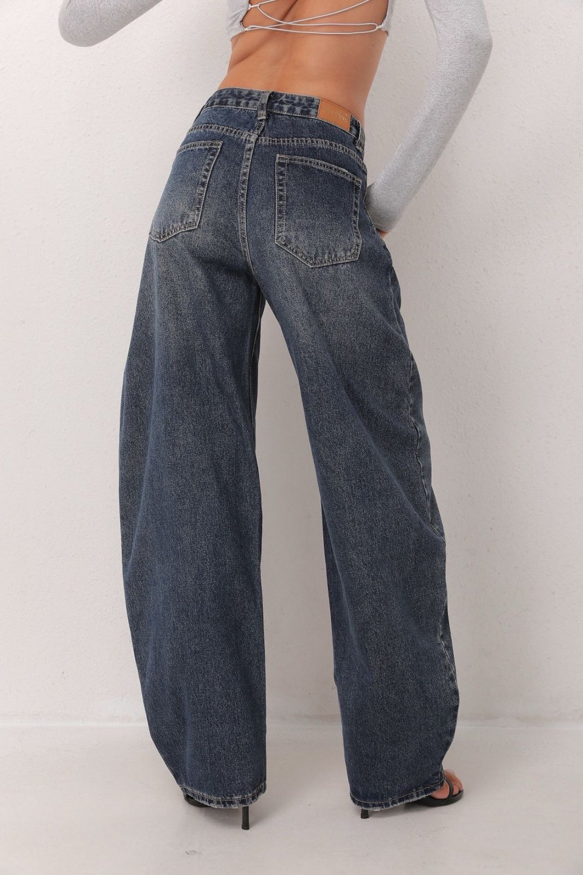 Person wearing blue wide-leg jeans 