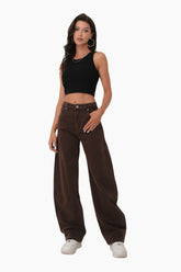 Woman wearing a black crop top and brown wide-leg pants 