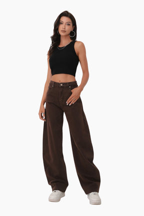 Woman wearing a black crop top and brown wide-leg pants 