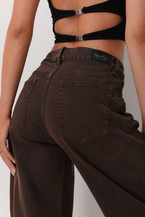 Brown jeans with a visible brand logo 