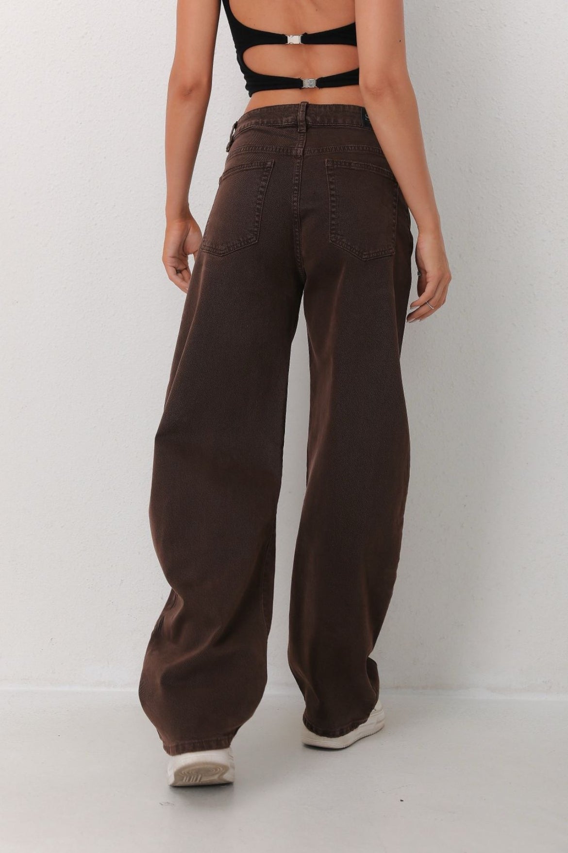Person wearing brown wide-leg pants 