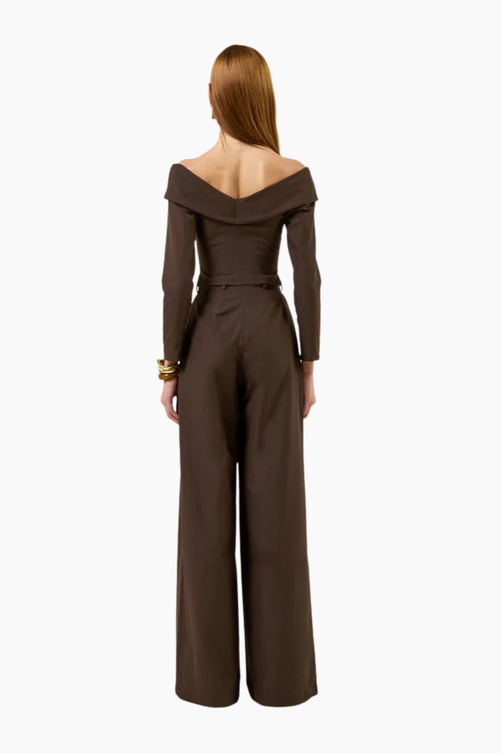 Brown jumpsuit worn by a model on a white background