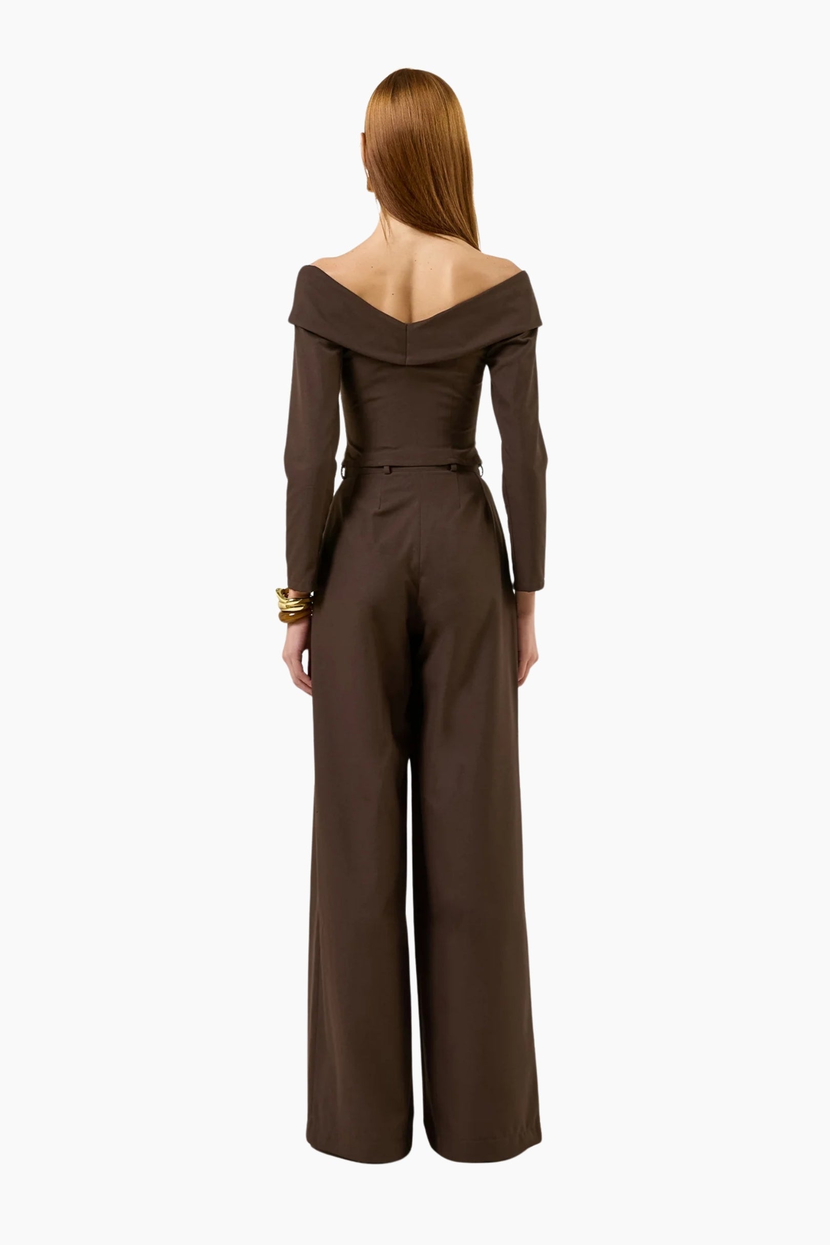 model wearing an Off-shoulder double-breasted long-sleeves top with brown pants.