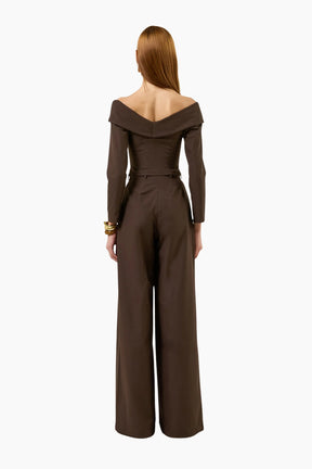 model wearing an Off-shoulder double-breasted long-sleeves top with brown pants.