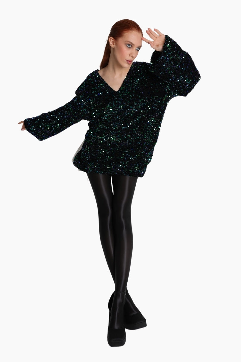 Person wearing a black sequin top and black tights 