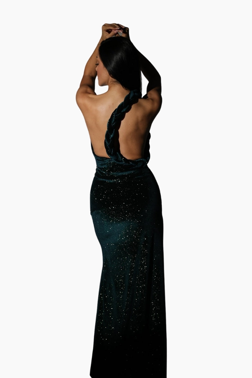 Woman wearing a black evening gown with a high slit 