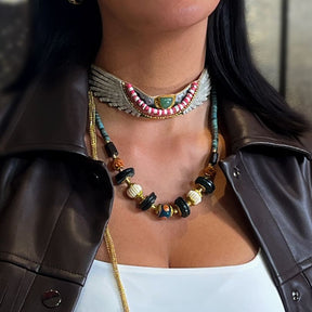 Person wearing a colorful beaded necklace with a leather jacket