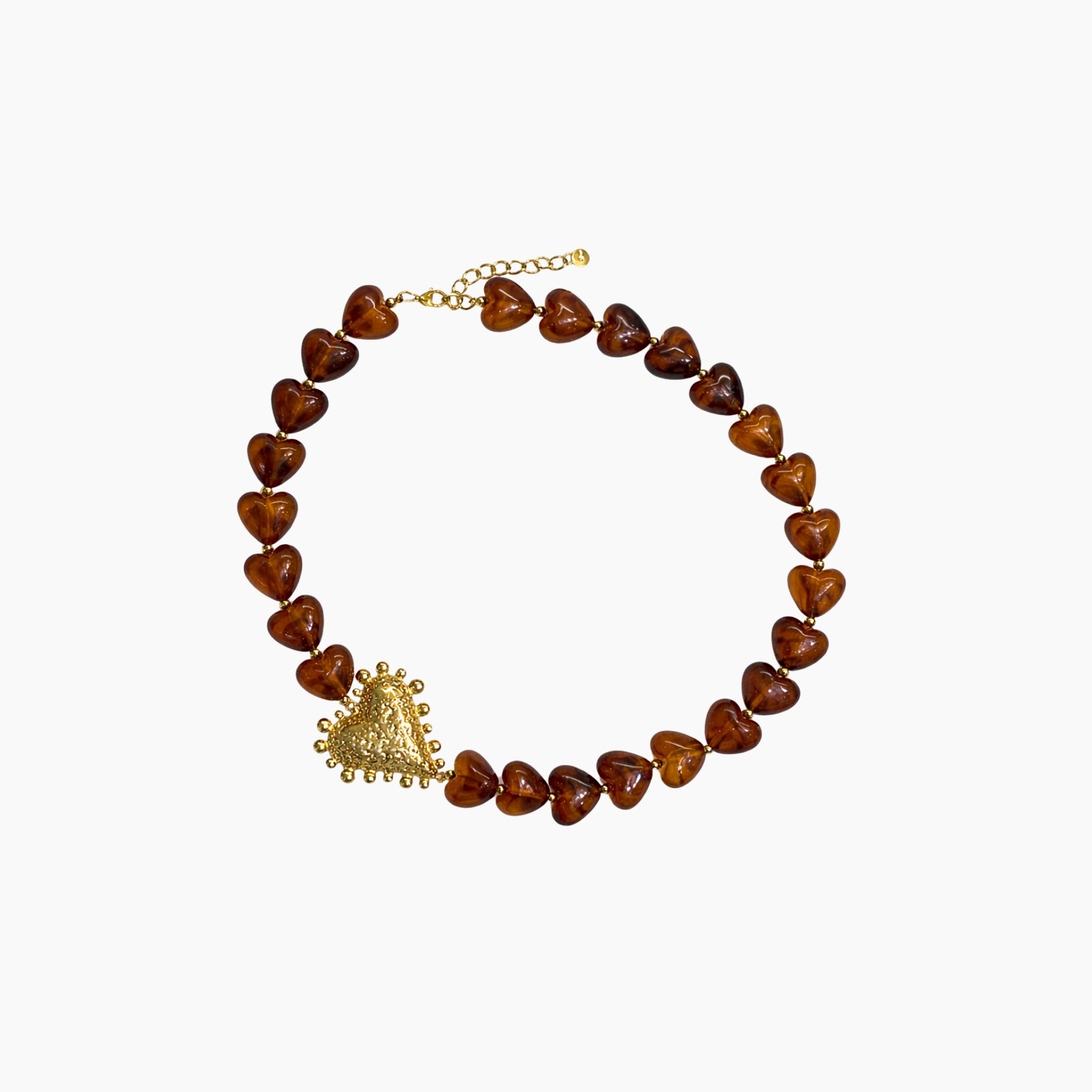 Necklace with heart-shaped brown beads and a gold pendant on a white background