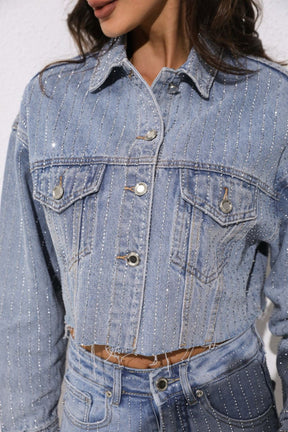 Close-up of a person wearing a light blue denim jacket 