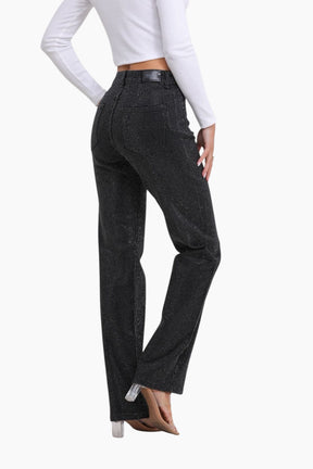 Black flared jeans worn by a person 