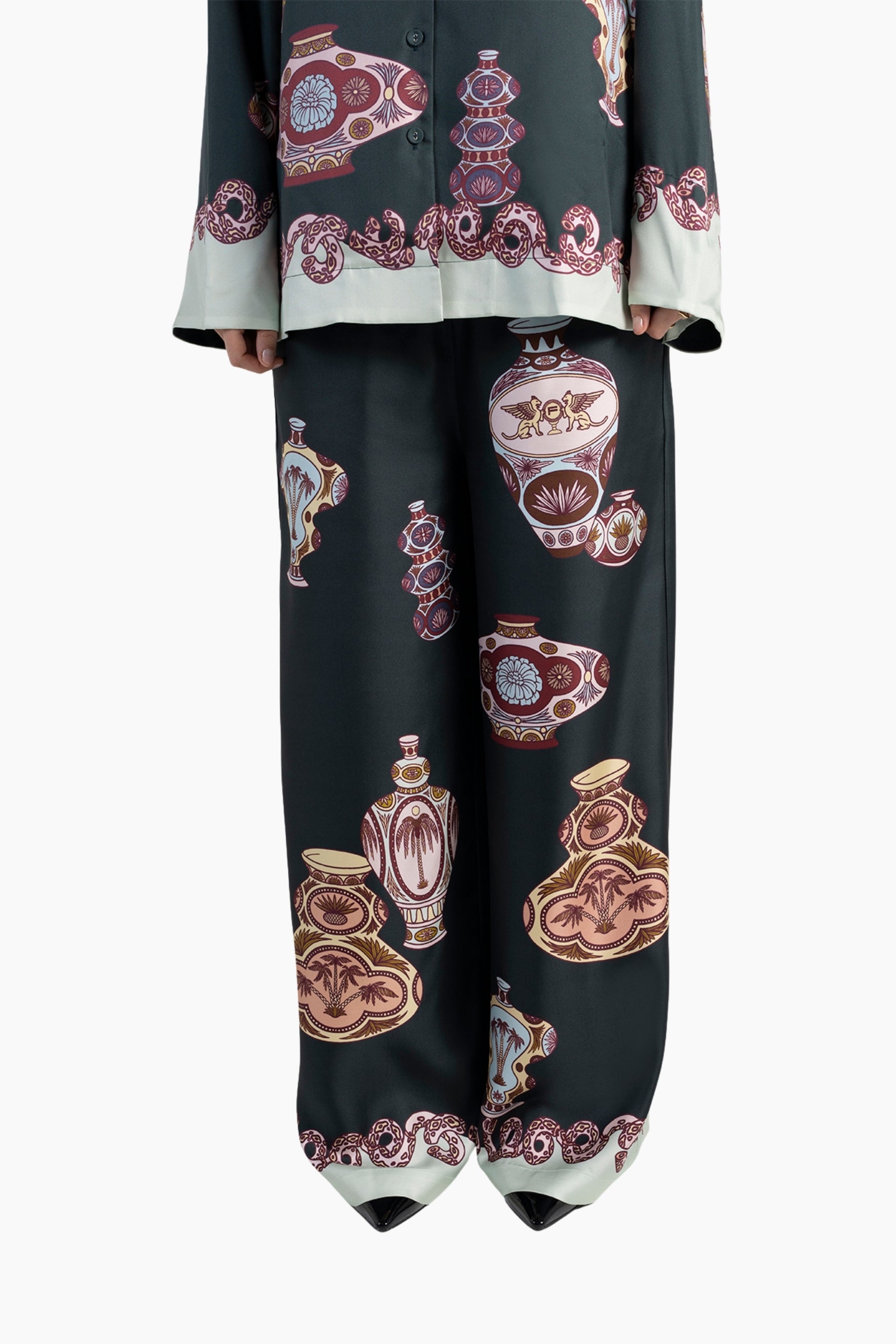 Black outfit with decorative patterns on a white background
