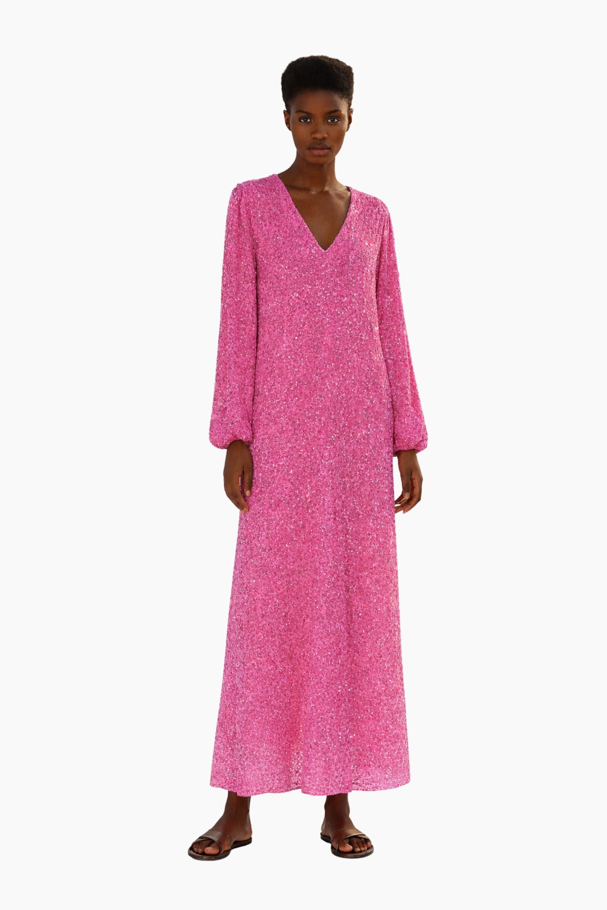 Woman wearing a pink long dress on a white background