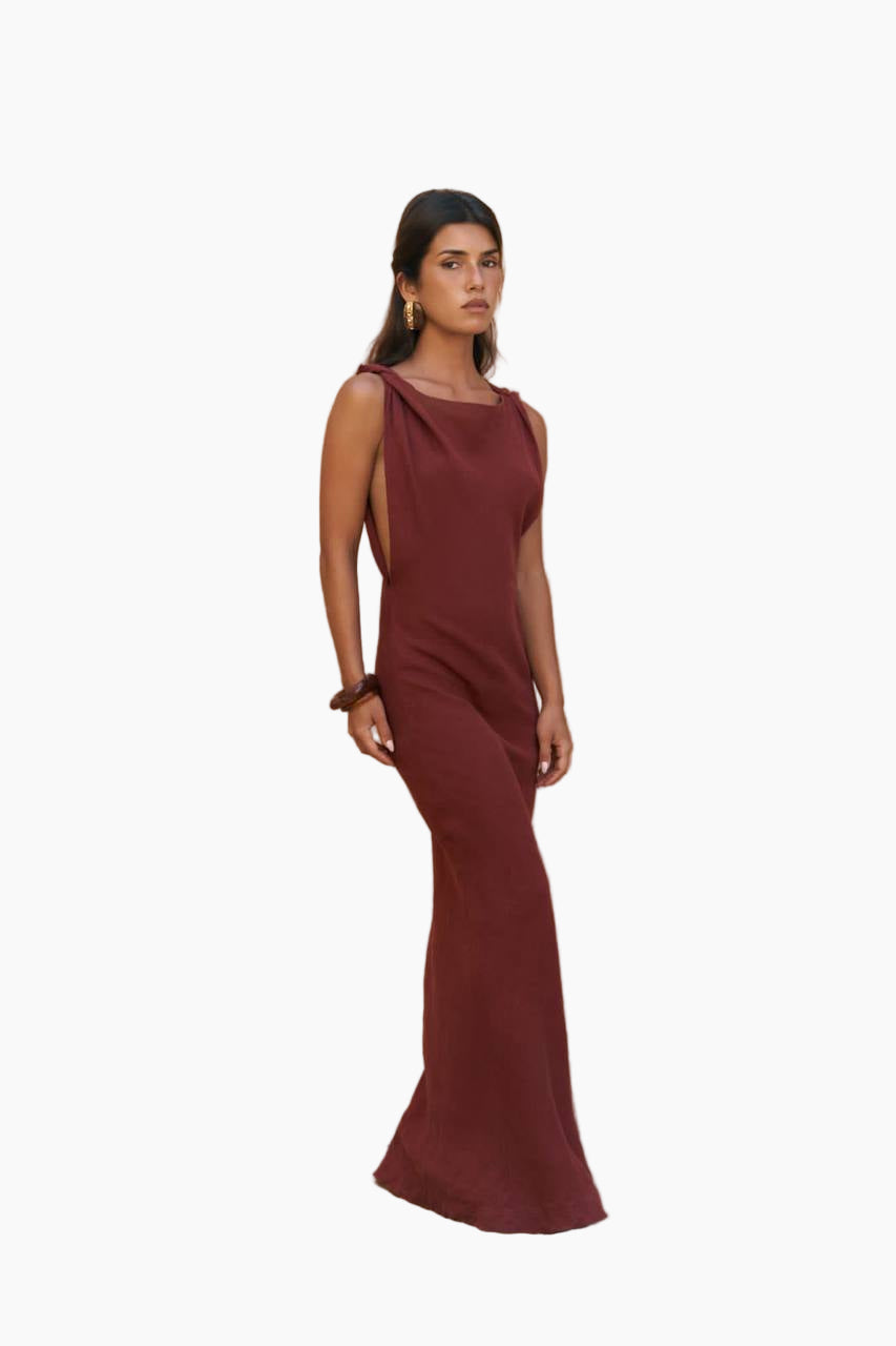 Woman wearing a burgundy dress on a white background