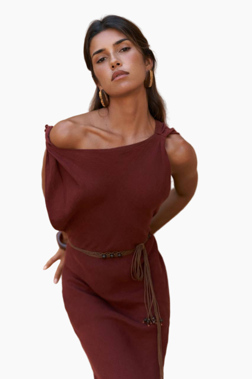 Woman wearing a burgundy off-shoulder dress with a belt on a white background