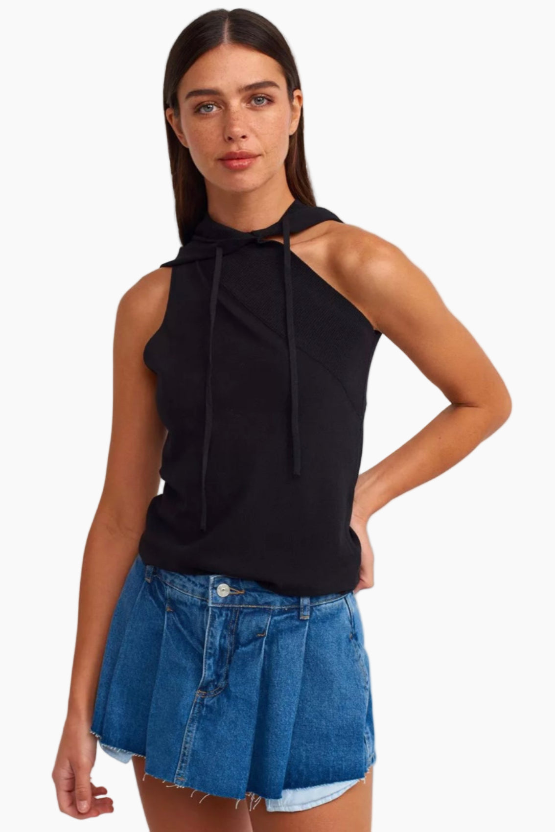 Woman wearing a black halter top and denim shorts on a white background