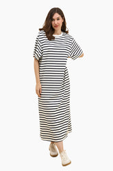 Woman wearing a black and white striped dress 