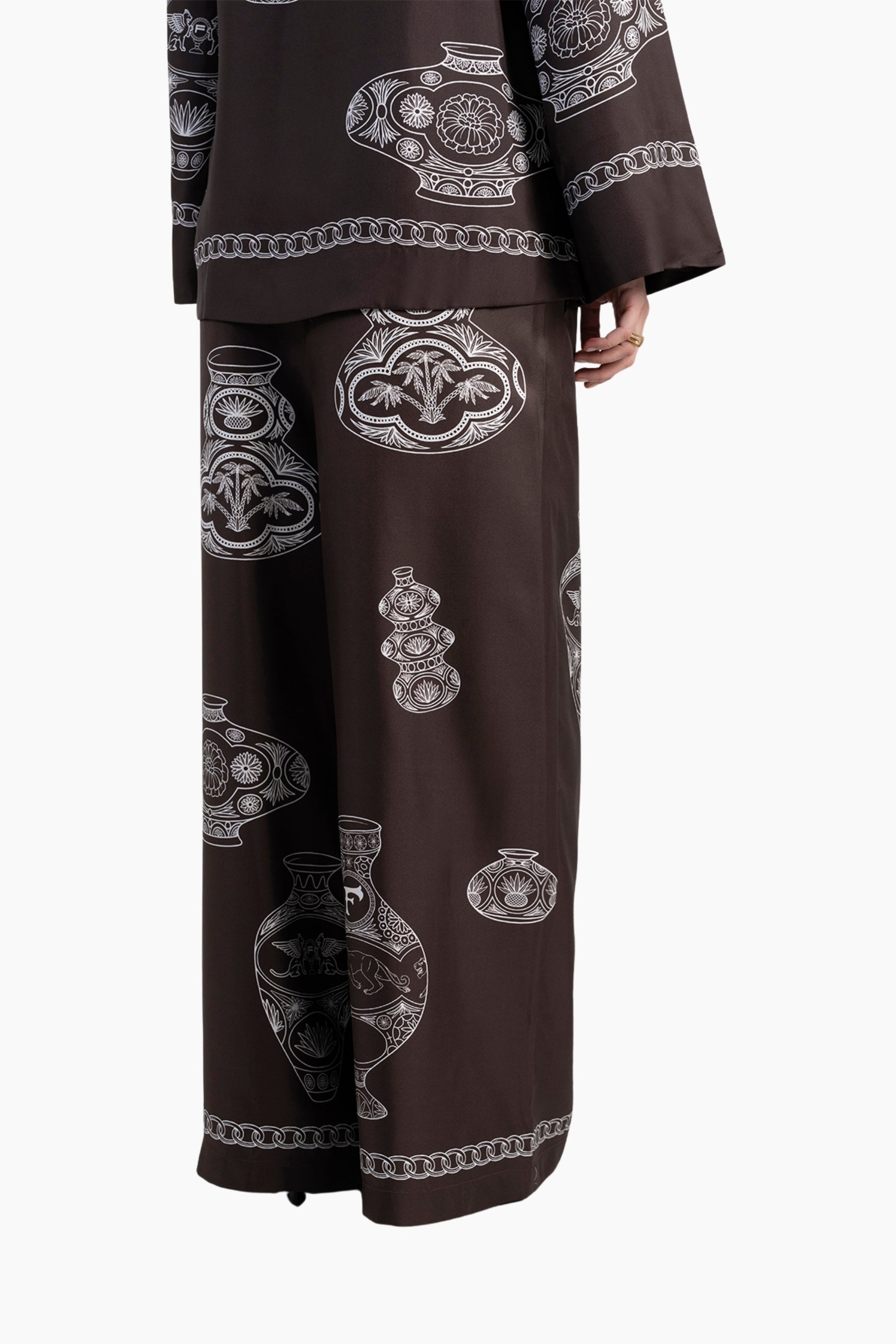 Brown outfit with intricate white patterns on a white background