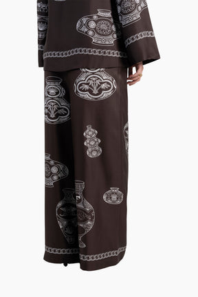 Brown outfit with intricate white patterns on a white background