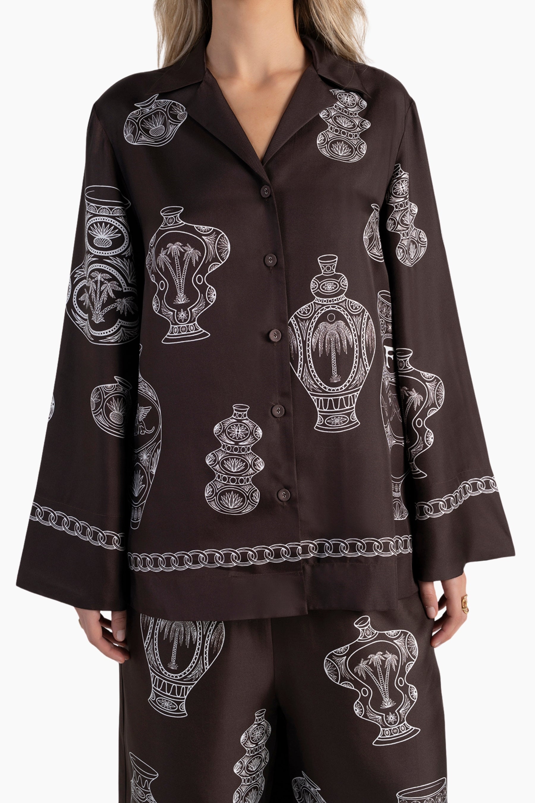 Brown shirt with white graphic design on a white background