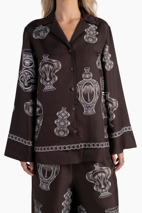 Brown shirt with white graphic design on a white background