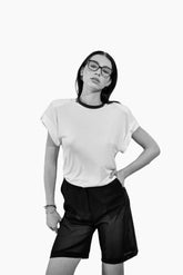 Person wearing a white t-shirt and black shorts 