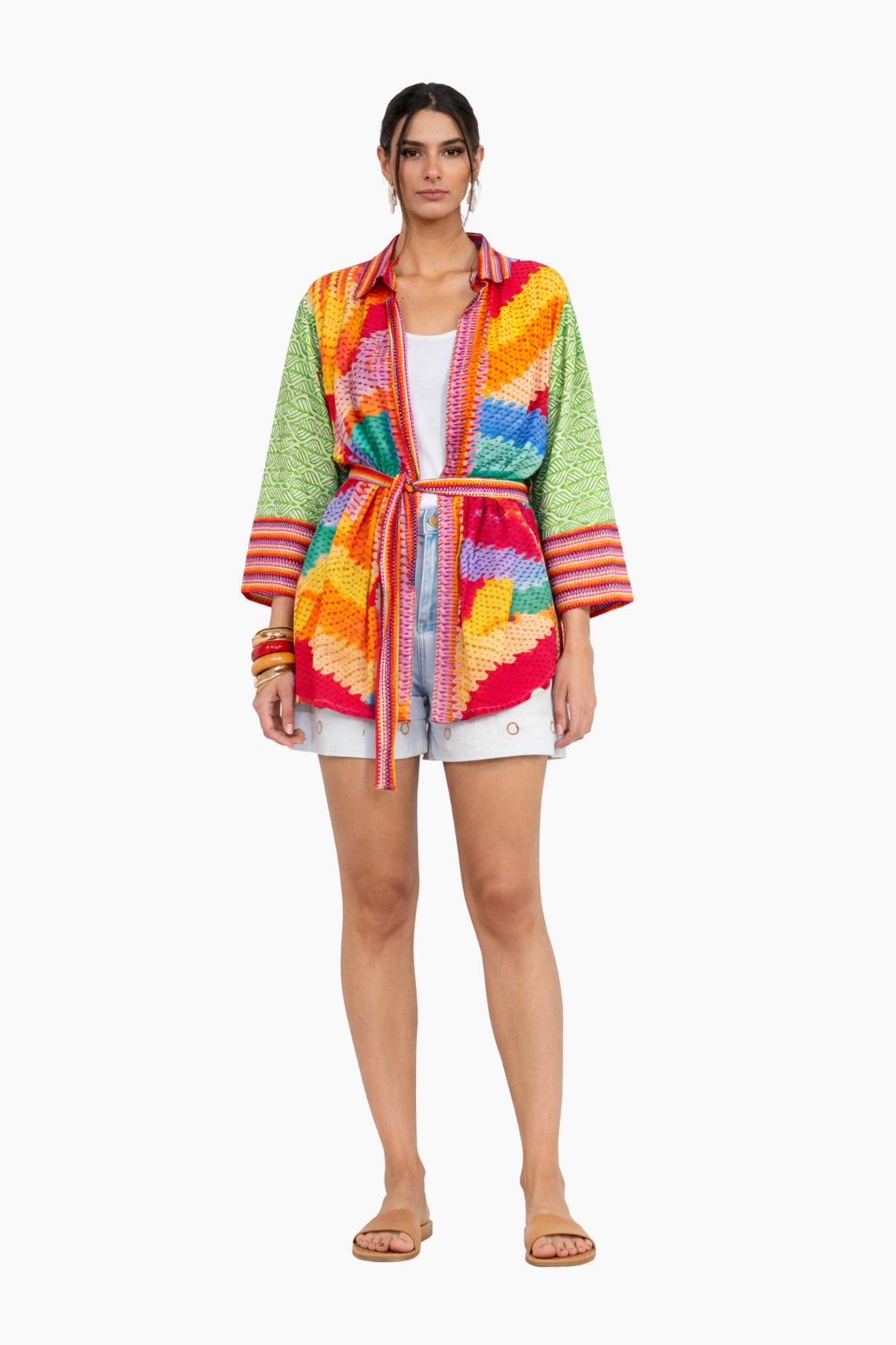 Woman wearing a colorful striped cardigan on a white background