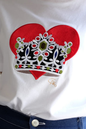 White shirt with a red heart and decorative crown design on a white background