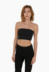 Woman wearing a black strapless top and black pants 