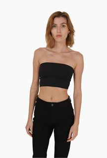 Woman wearing a black strapless top and black pants 