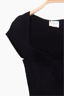 Black ribbed sweater on a hanger with a visible brand tag 