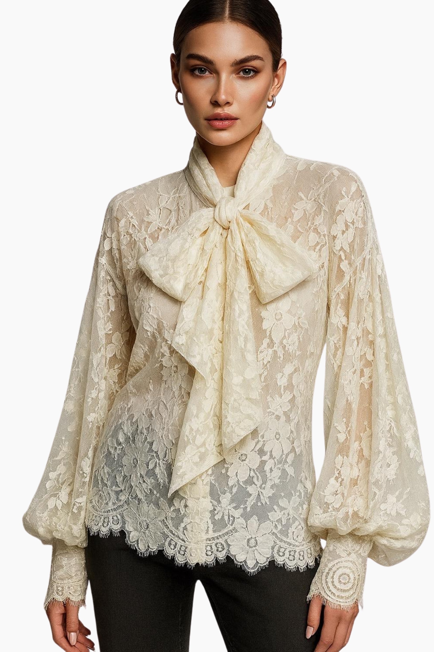 Woman wearing a beige lace blouse with a large bow tie on a white background