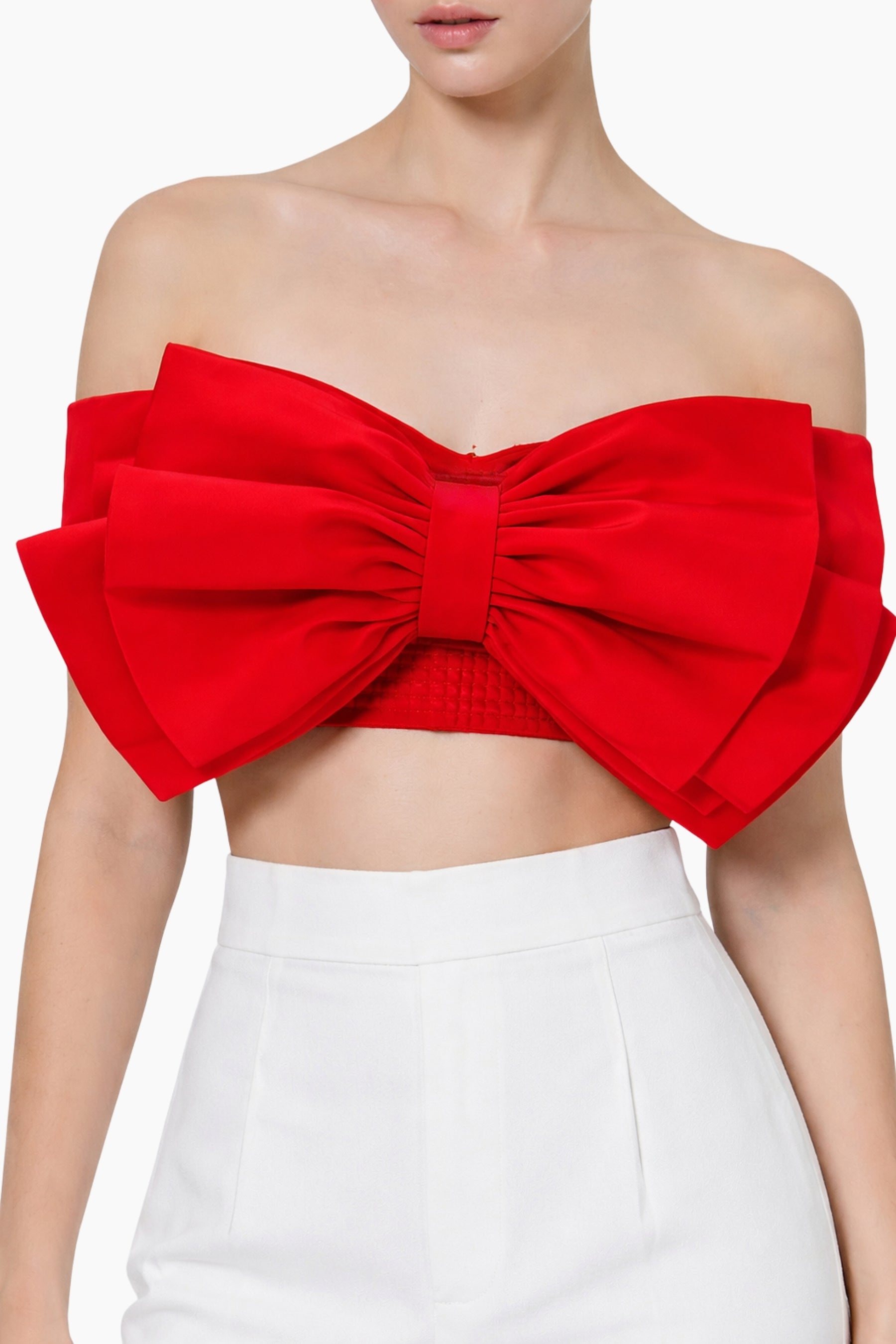 Red strapless top with a large bow detail on a white background