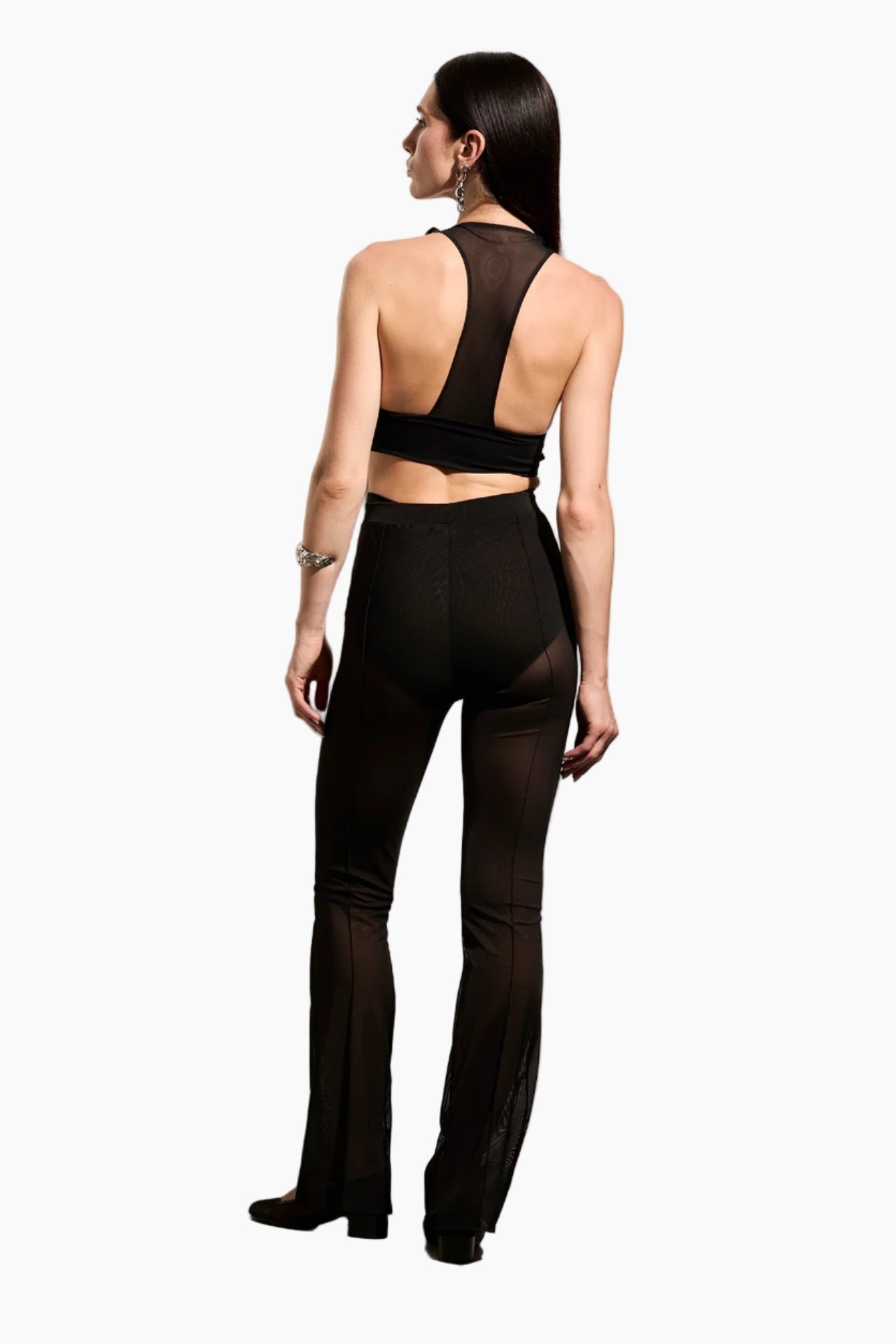 Woman wearing a black outfit with sheer pants