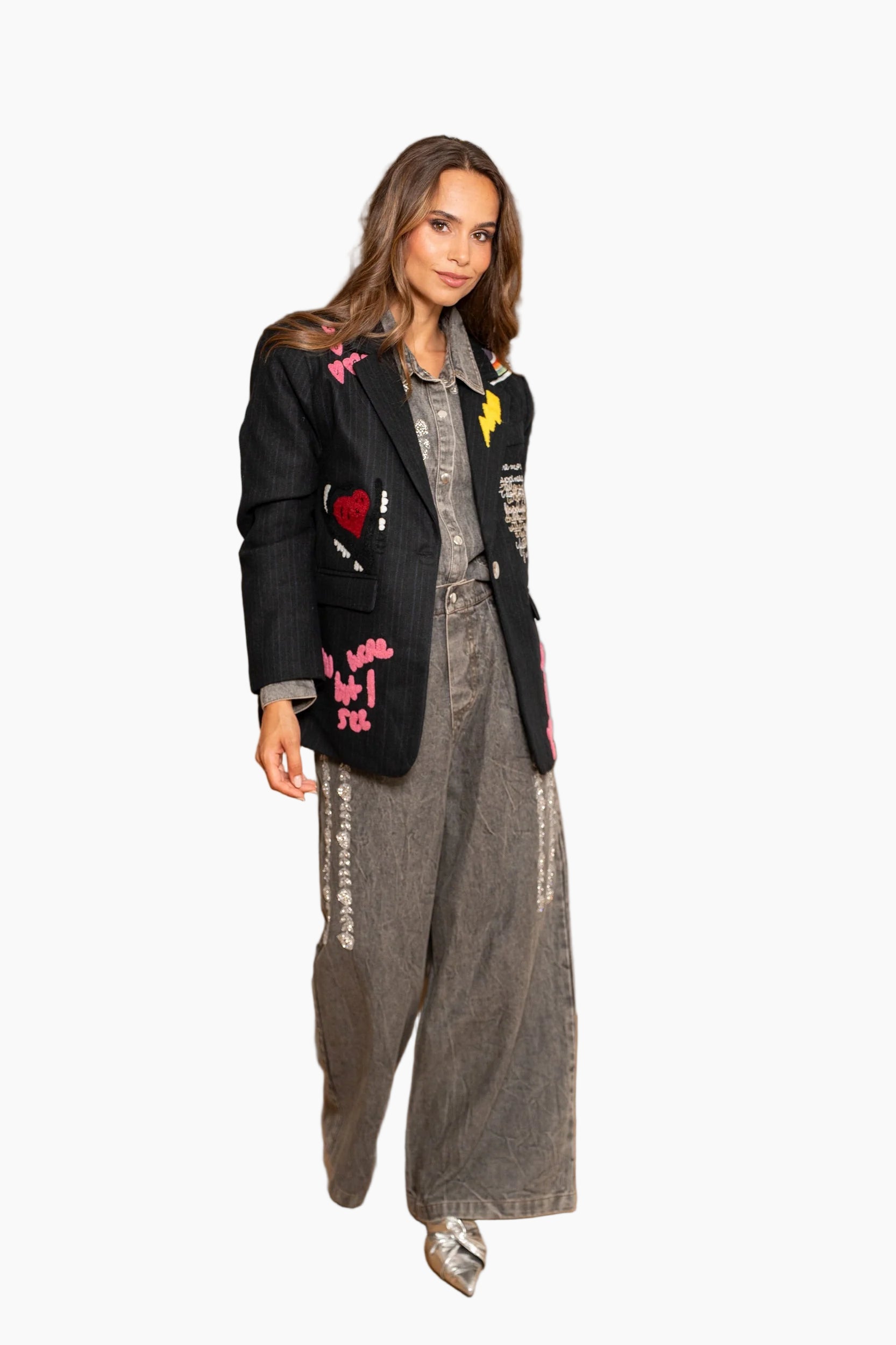 Woman in stylish outfit with text on jacket