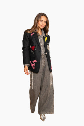 Woman in stylish outfit with text on jacket