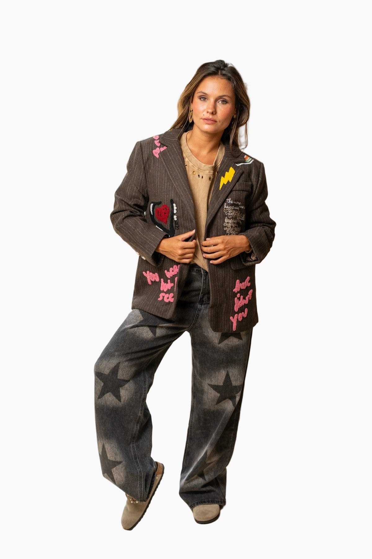 Woman wearing a stylish outfit with a jacket and pants