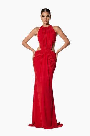 Woman wearing a  maxi red evening gown with side cuts