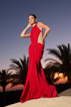 Woman wearing a maxi red evening gown with side cuts