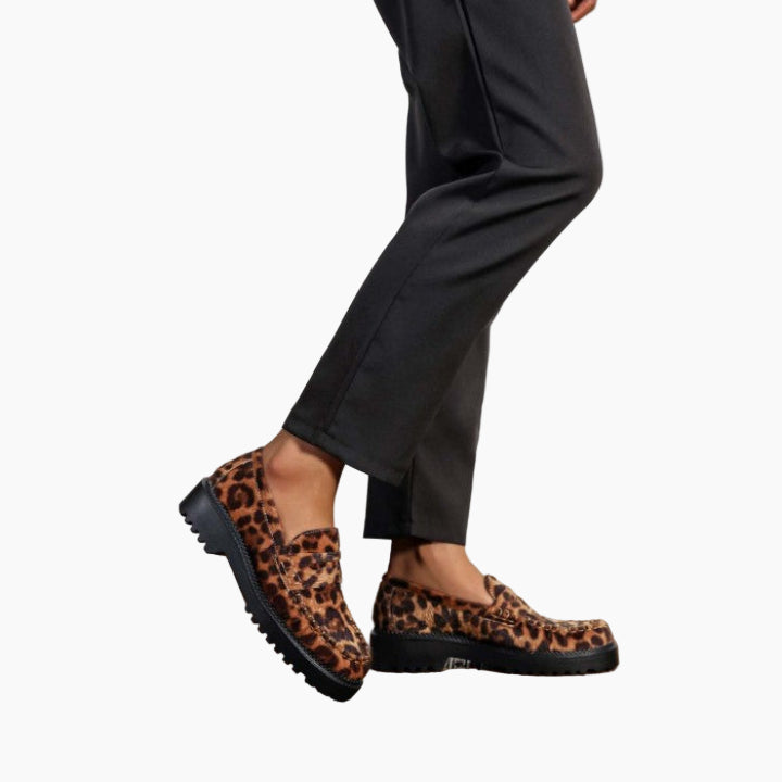 Leopard print loafers worn with black pants 